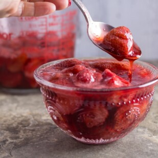 Roasted strawberries and sauce in a bowl.