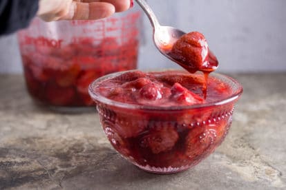 Roasted strawberries and sauce in a bowl.