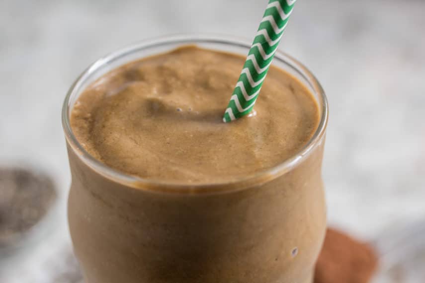 A close up of a Mocha Banana Smoothie with a green straw