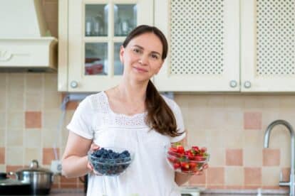 Woman with bowls of berries.