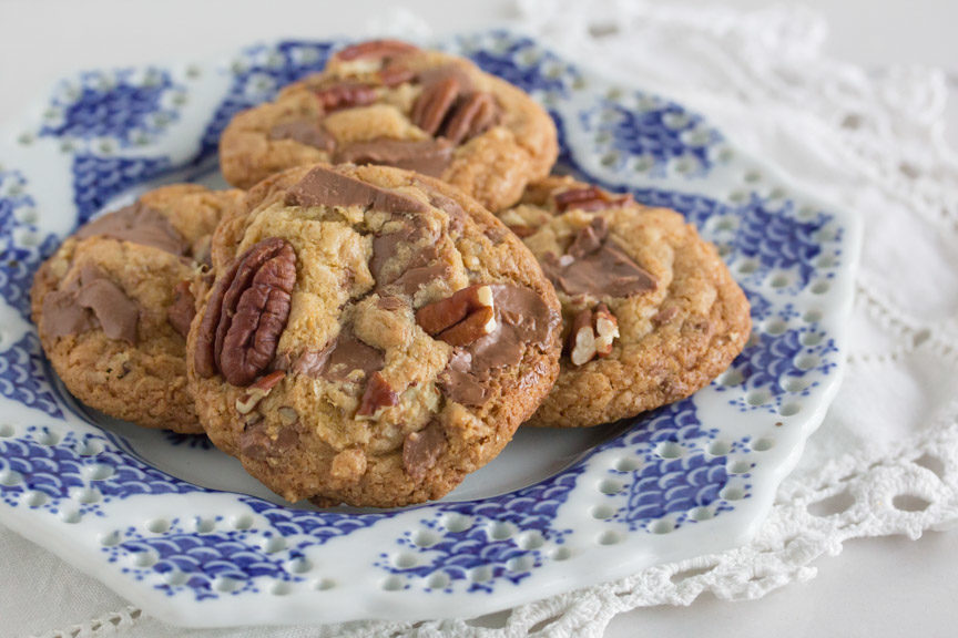 A plate of delicious gluten free milk chocolate chunk cookies with pecans.