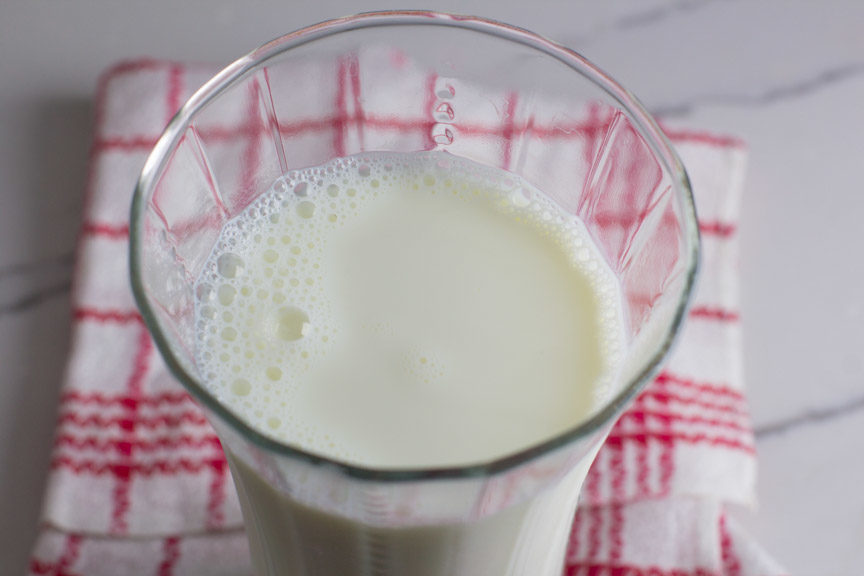 A tall glass of lactose free milk from above. 