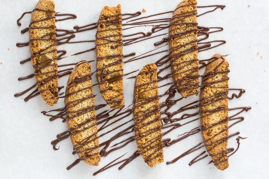 low-FODMAP-triple-ginger-biscotti-drizzled-with-chocolate-on-parchment-lined-pan.