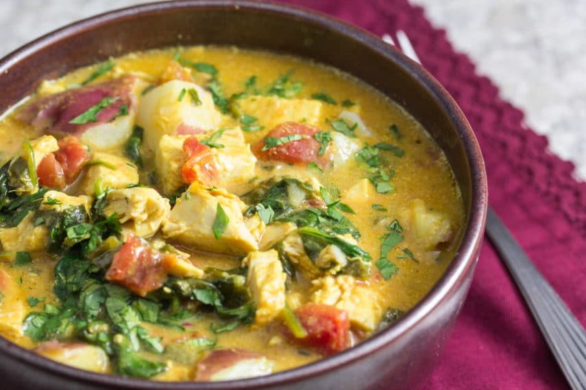 Turkey Coconut Curry with spinach in a rustic bowl