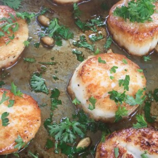 Carmelized juicy pan friend scallops served with fresh lettuce.