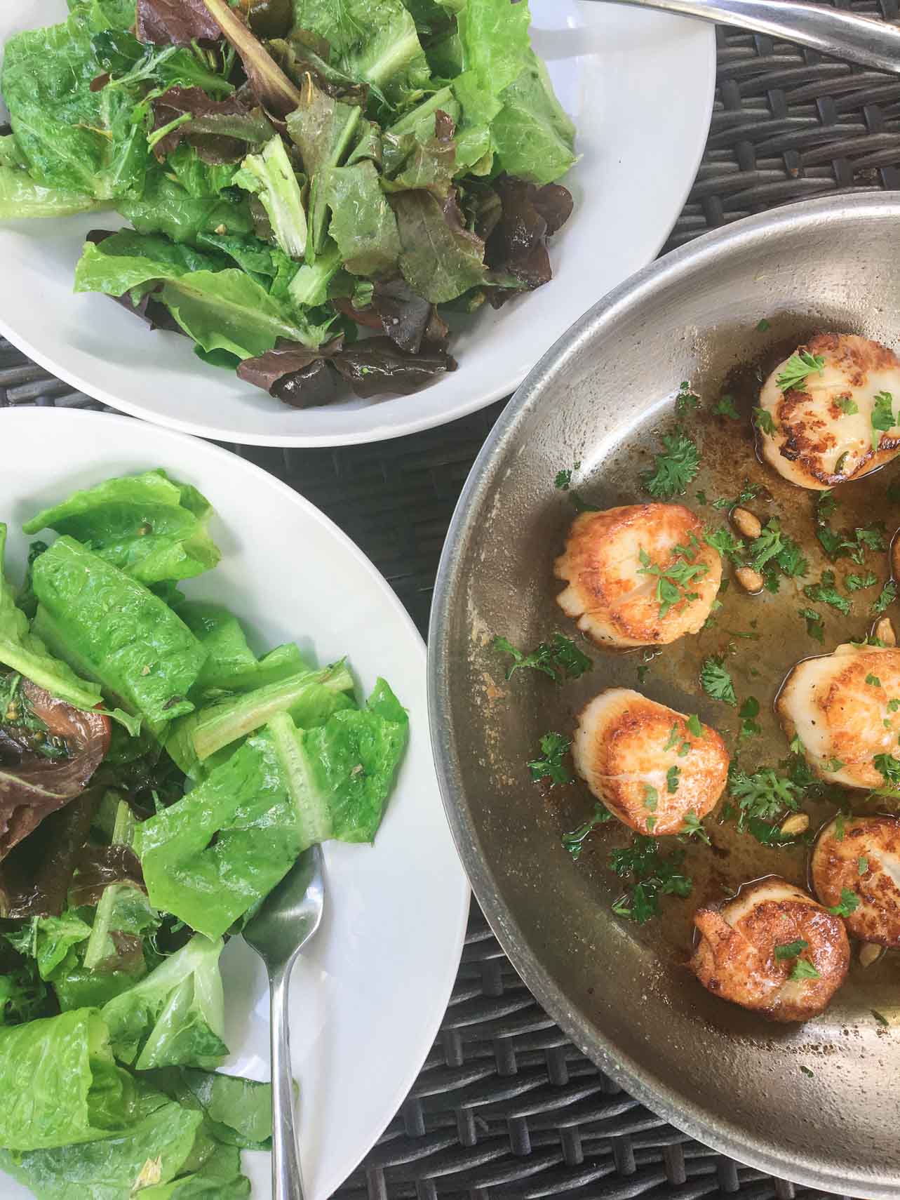 Carmelized juicy pan friend scallops served with fresh lettuce. 