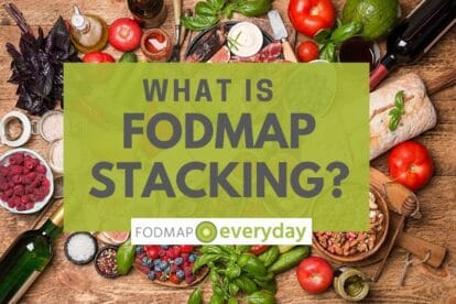 Backround is fruits and vegetables on a table with a title What Is FODMAP Stacking atop of them.