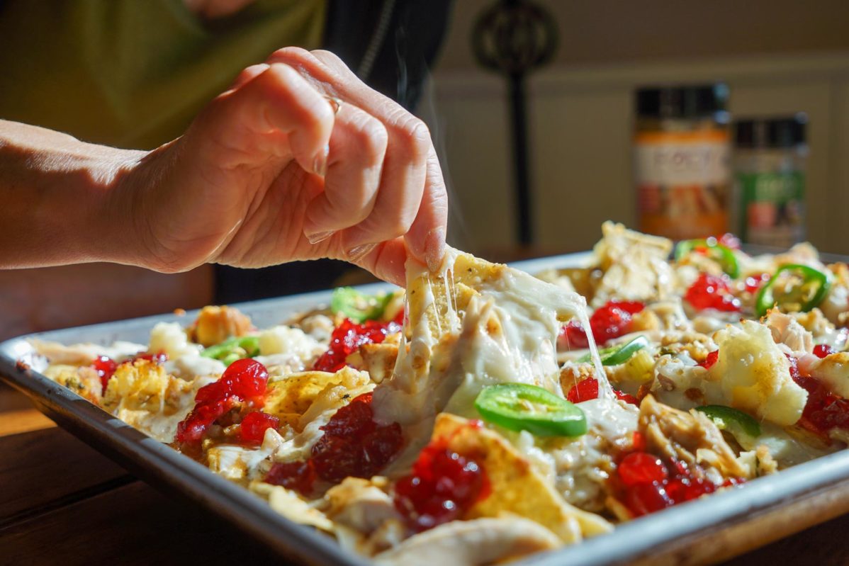 Digging in to Thanksgiving nachos fresh out of the oven withe melted cheese