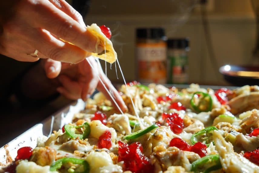 Taking a serving of Thanksgiving nachos right off of the pan