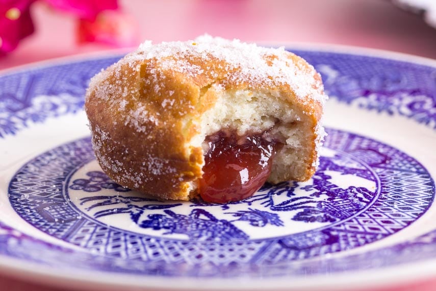 closeup of low FODMAP gluten-free jelly doughnuts on decorative blue plate