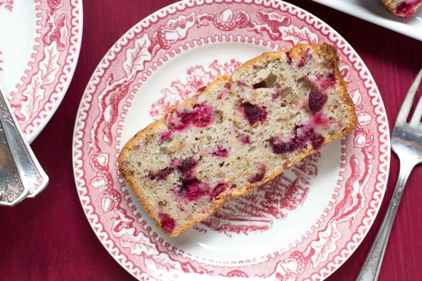 Slice of cranberry quick bread on an antique plate