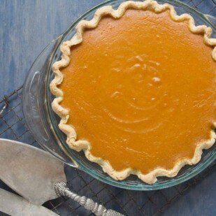 pumpkin pie sweetened with maple and enhanced with fresh lemon zest and fresh ginger on a cooling rack