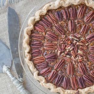 Overhead image of Browned Butter Salted Caramel Pecan Pie in a chocolate flecked pastry crust