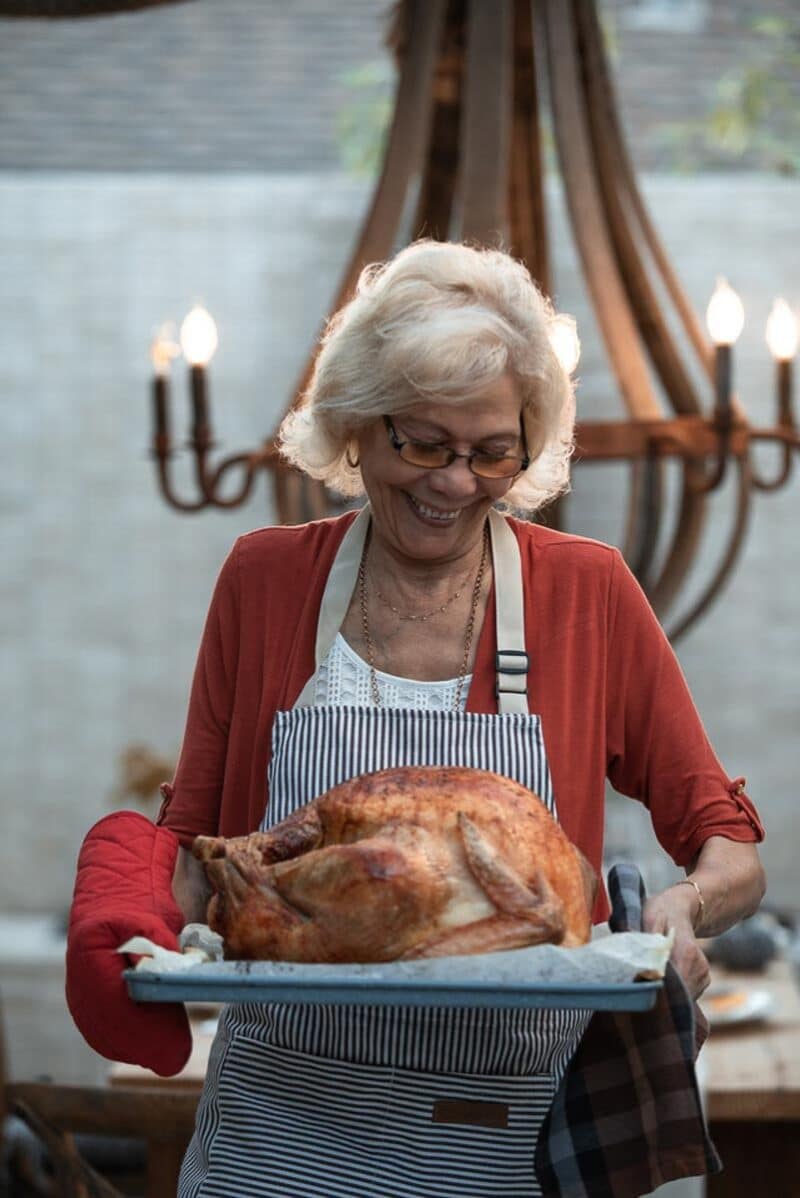 woman holding turkey on platter