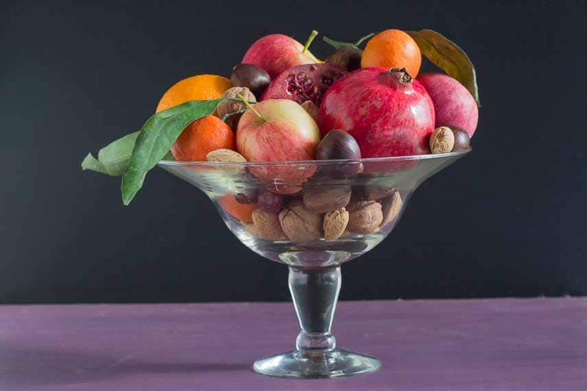 Low FODMAP fruits and nuts along with apples in a clear glass compote dish. Tips for Hosting a party