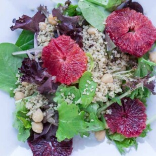 Grains & Greens: Baby Lettuces, Blood Oranges, Quinoa & Chickpeas on a white plate