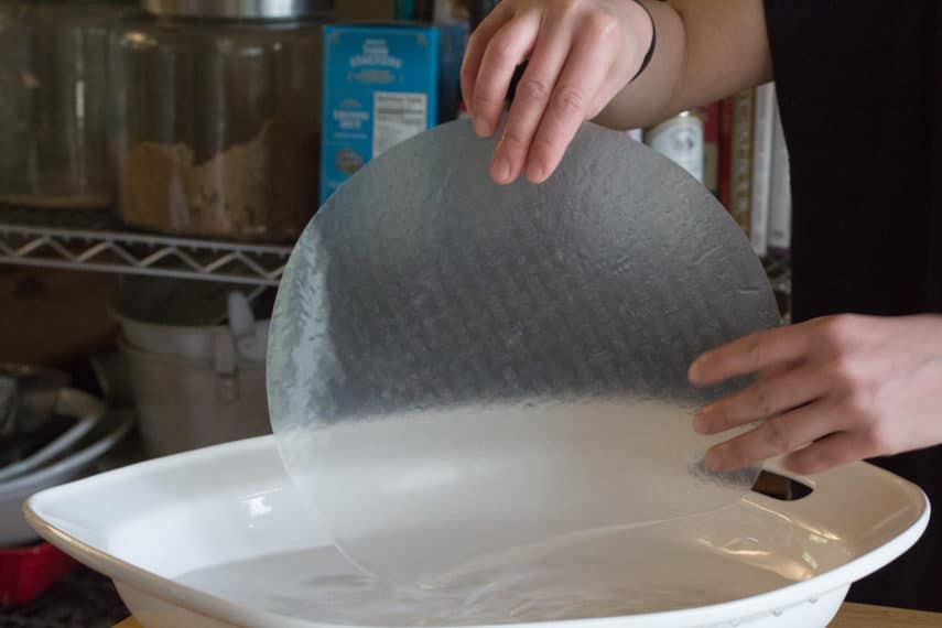 dipping rice papers in water for summer rolls copy