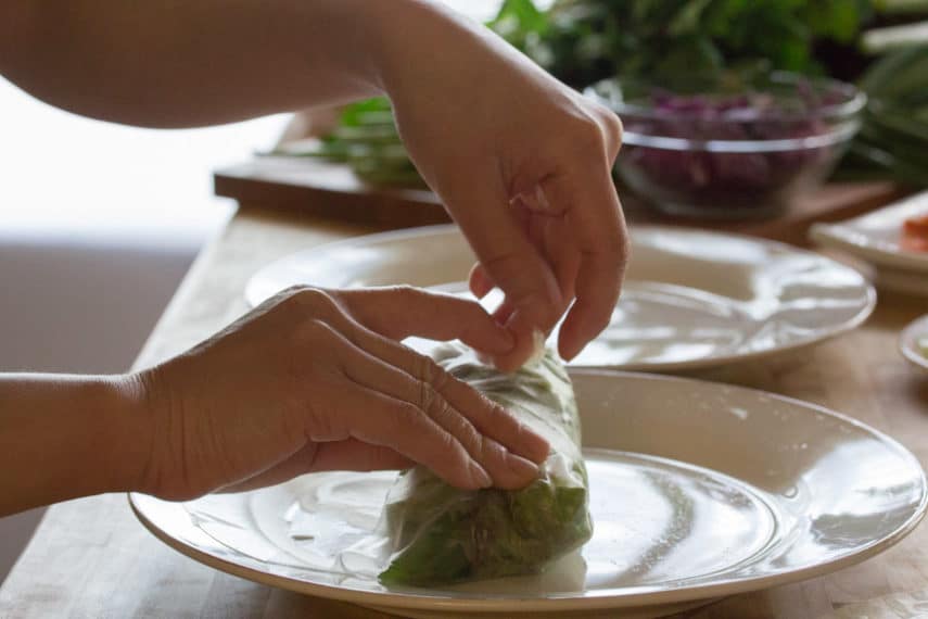 hands rolling summer rolls