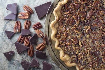 overhead image of chocolate pecan pie with whiskey with fluted crust
