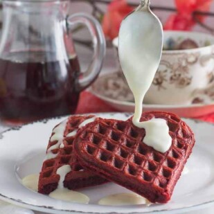 Gluten Free Low FODMAP red velvet waffles with lactose free cream cheese drizzle on top