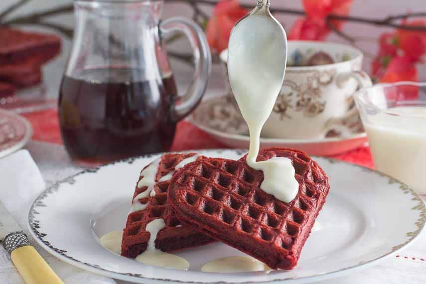 Gluten Free Low FODMAP red velvet waffles with lactose free cream cheese drizzle on top