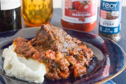 short ribs with red wine and horseradish on a blue plate