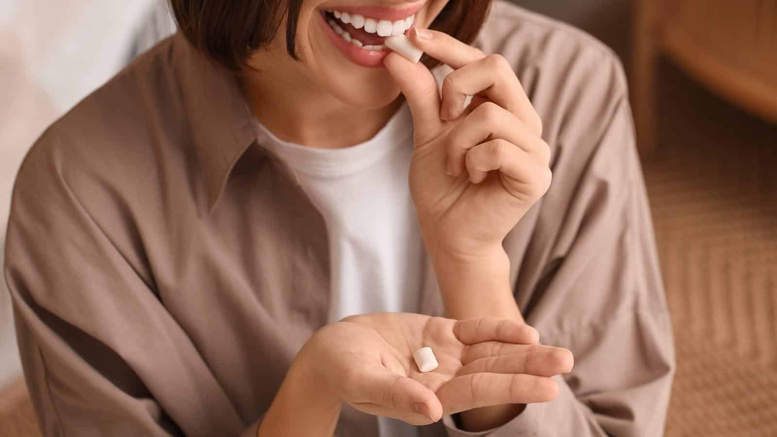woman eating breath mint. serezniy via 123rf.