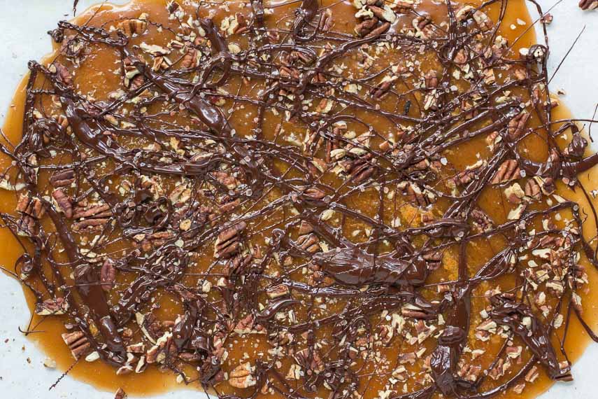 top view of pecan toffee, drizzled with chocolate, on pan