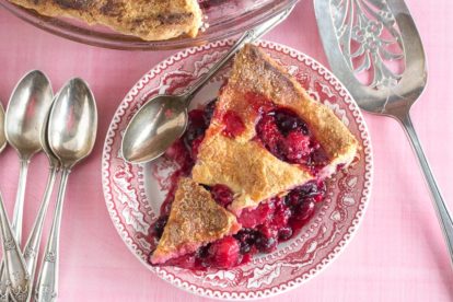 berries pie, on a pink background, with decorative cut-outs in crust