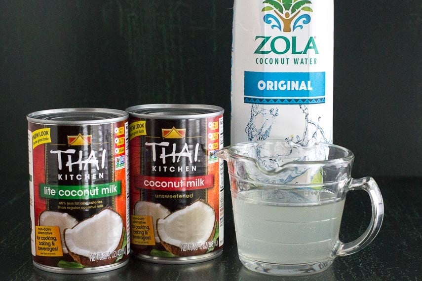 Is Coconut Low FODMAP? canned coconut milk and carton of coconut water against a dark background