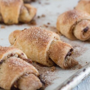 closeup of rugelach on parchment lined pan