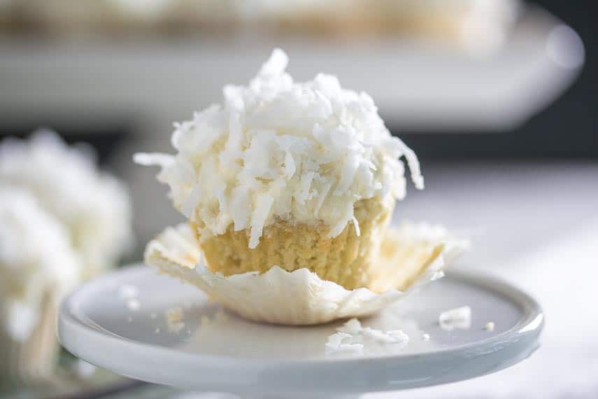 mini coconut cupcake, up close on a white plate