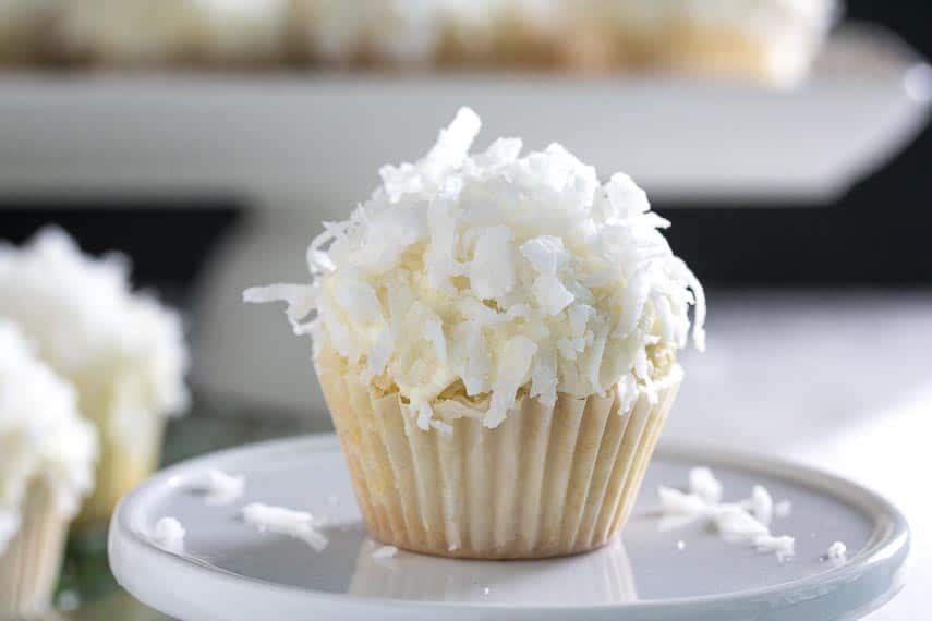 mini coconut cupcake, up close on a white plate