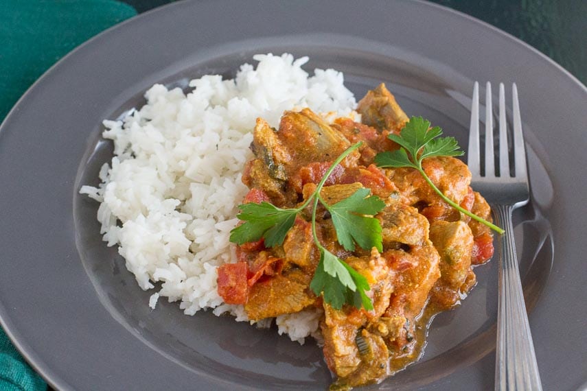 easy lamb curry and basmati rice on a gray plate with fork alongside