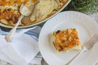 potato gratin in a casserole dish in the background; on a plate in the foreground