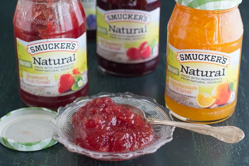 Smucker's Natural Fruit Spreads in jars and in a glass dish with silver spoon