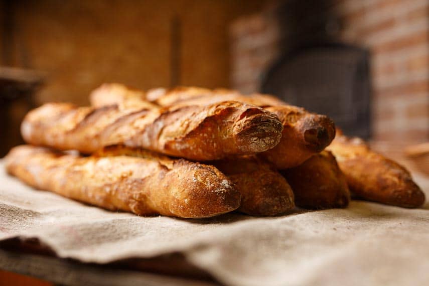 baguettes stacked up on a piece of linen