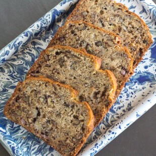 low FODMAP reduced sugar banana bread on blue and white platter
