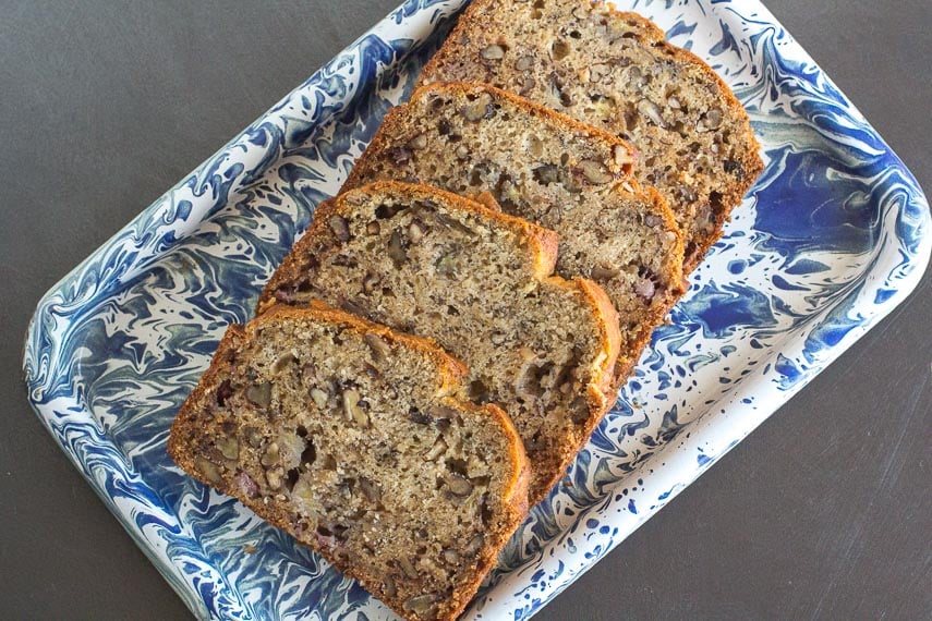 low FODMAP reduced sugar banana bread on blue and white platter