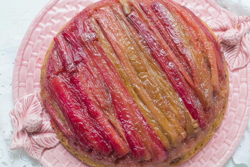 rhubarb upside down cake overhead on a pink platter
