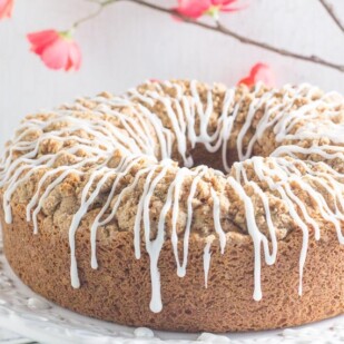 cinnamon streusel coffee cake with white icing drizzled on top