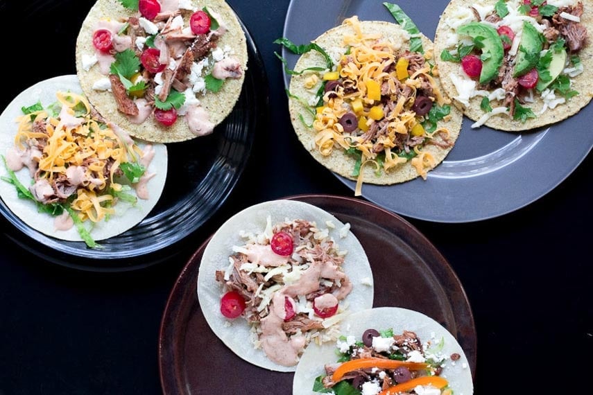 Shredded Pork Tacos on corn tortillas with various low FODMAP toppings