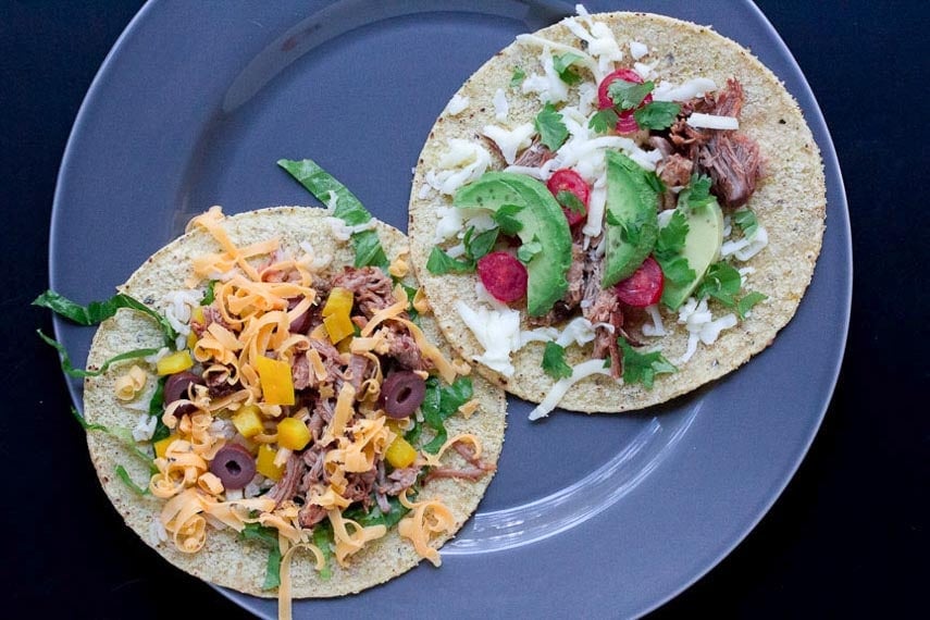 Shredded Dry Rubbed Slow-Roasted Pork on corn tortillas on a gray plate