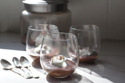 e almond milk pudding with coconut whipped cream in glasses