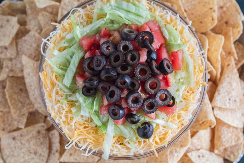 overhead shot of 7 layer dip surrounded by corn chips