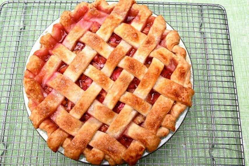 Rhubarb Pie with Lattice Crust on rack against green background