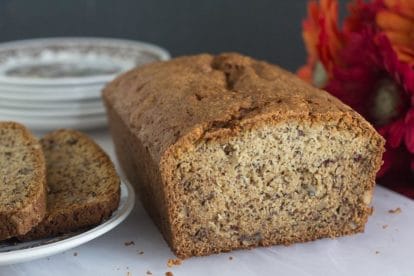 FODMAP IT Nana's banana bread closeup on white cutting board with Gerbera daisies in background