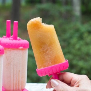 Arnold Palmer Ice Pops with a bite out in a pink holder