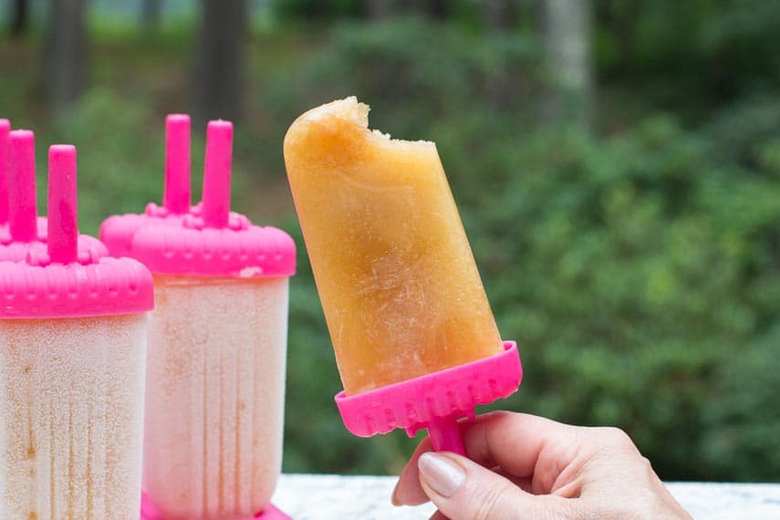 Arnold Palmer Ice Pops with a bite out in a pink holder