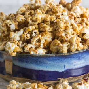 Sweet n spicy kettle corn in a shallow blue ceramic bowl